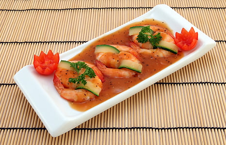shrimp with sauce on white ceramic plate