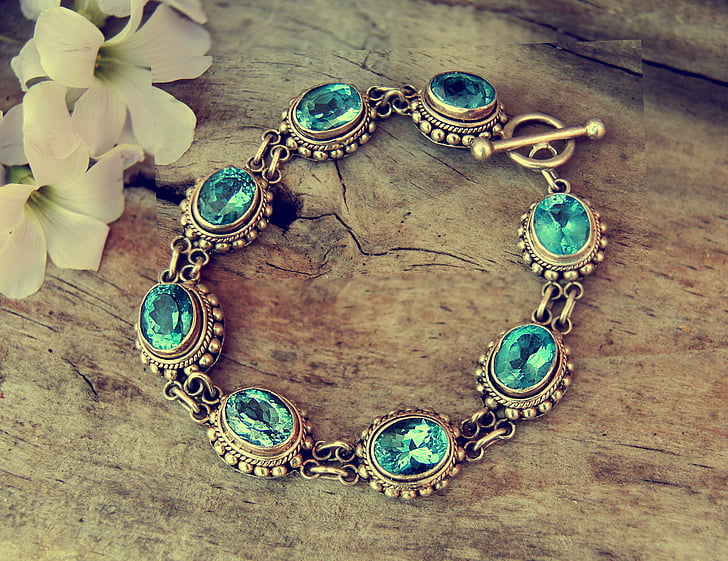 gold-colored blue gemstone encrusted bracelet