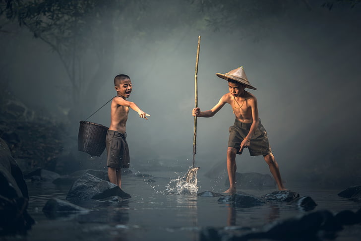 two boy playing on water