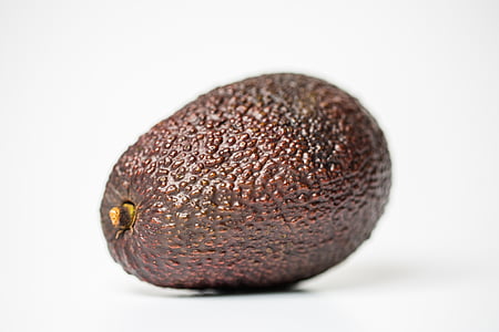 brown avocado on white surface