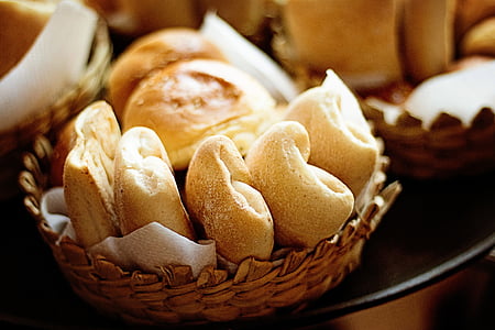 baked breads in round brown wicker bowl