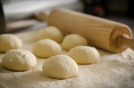 rolling pin beside several doughs