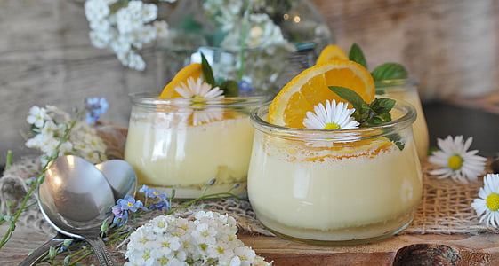 clear glass jars with slice of lemons and yellow cream