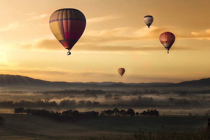 several hot air balloons above ground photo