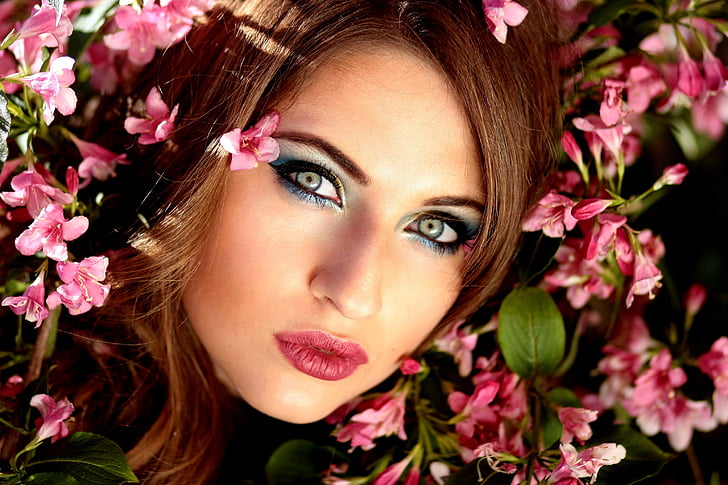 woman in pink lips surrounded with pink flowers