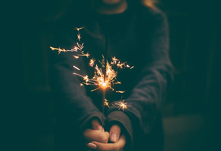 person's hand holding fireworks