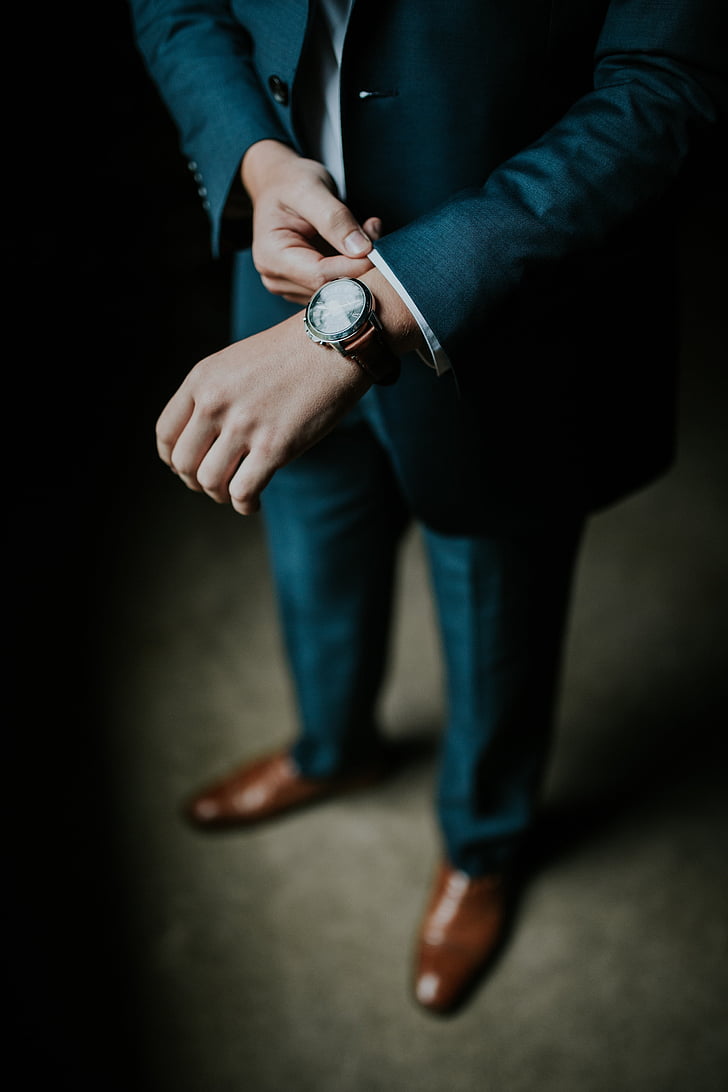 man wearing blue suit jacket with watch