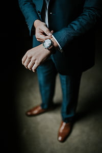 man wearing blue suit jacket with watch
