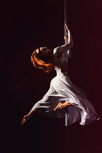 woman dancing on pole
