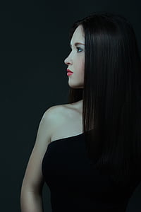 woman wearing black top looking at her right side