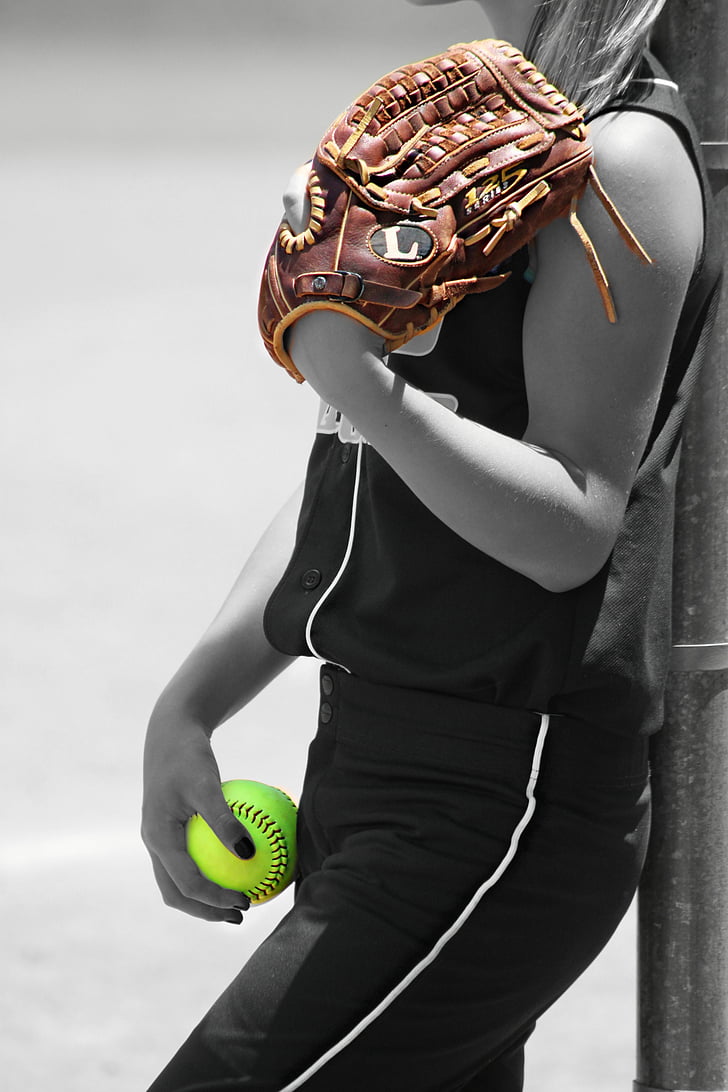 woman holding baseball mitt and ball