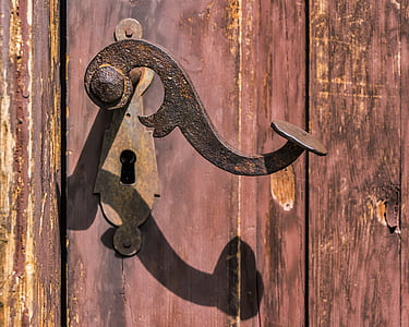 black door lever and keyhole on door