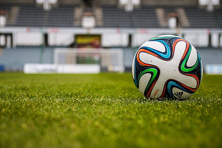 closeup photo of white, orange, black, and blue Adidas soccer ball
