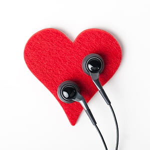 black earphones on red heart decor