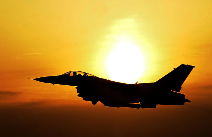 timelapse photography of black fighter plane during golden hour