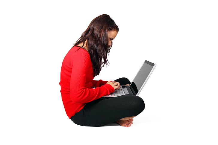 woman wearing red long-sleeved shirt holding laptop