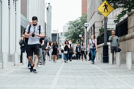 low-angle photography of group of people walking on the side of the streets