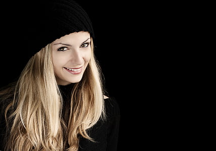 woman wearing black hat smiling