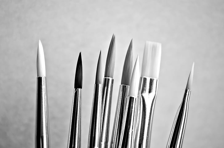 grayscale photograph of paint brushes