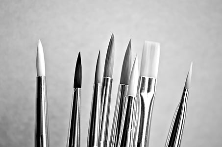 grayscale photograph of paint brushes