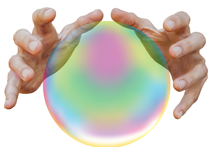 person's hands near iridescent ball