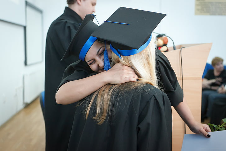 two women hugs during graduation