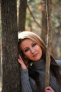 woman in gray sweater near tree
