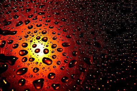 droplets on brown glass surface