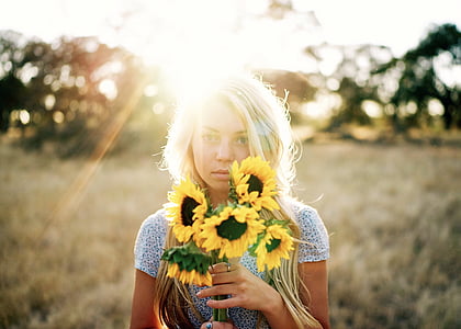 woman holding sunflower