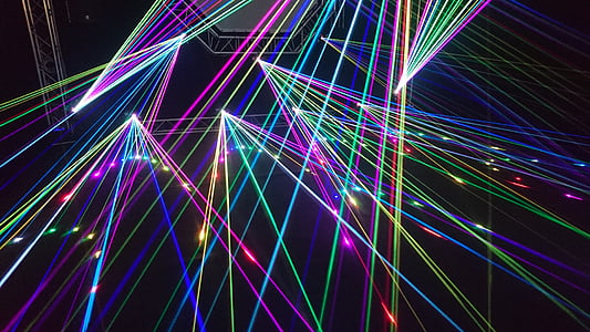 multicolored disco light rays on black background