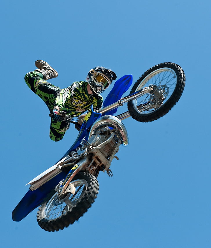 man riding blue motocross dirt bike