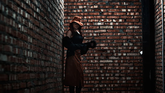 woman near brown concrete wall