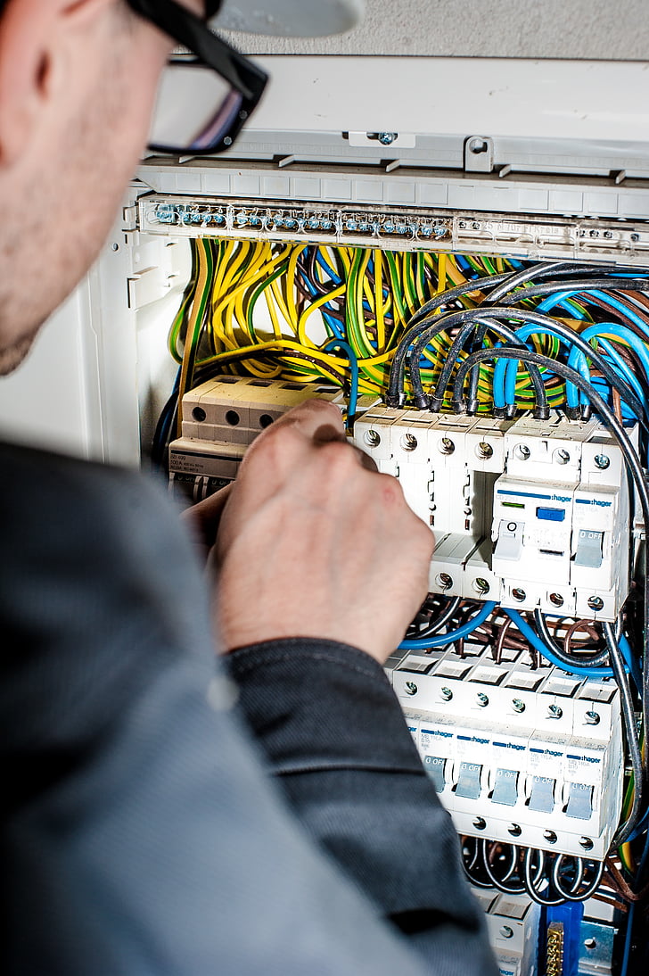 men fixing circuit board in control board