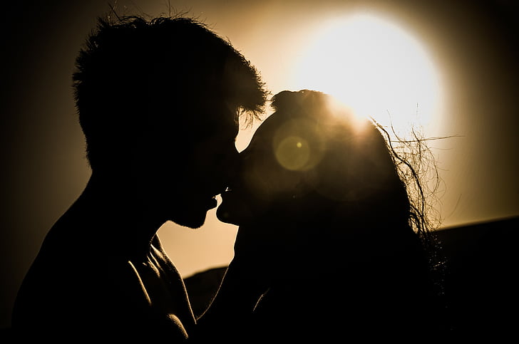 silhouette photo of kissing couple