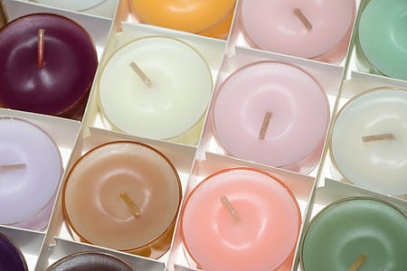 assorted-color votive candles on box