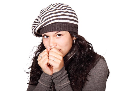 woman with white and black striped knit cap and black long-sleeved top