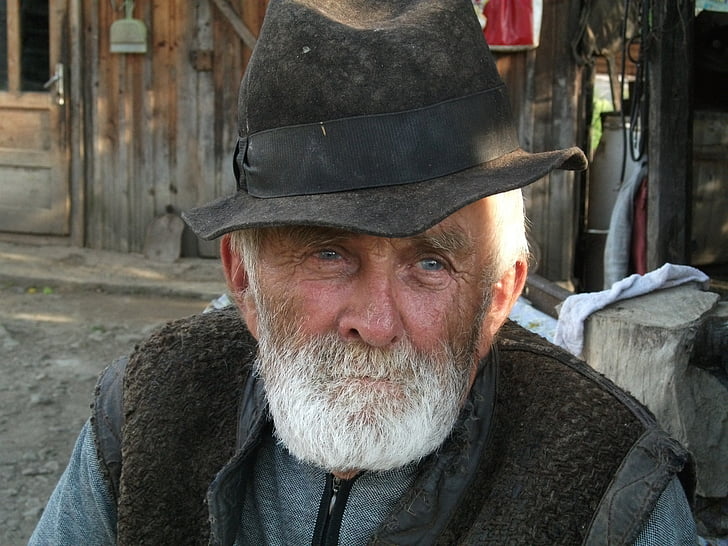 man wearing hat and black vest