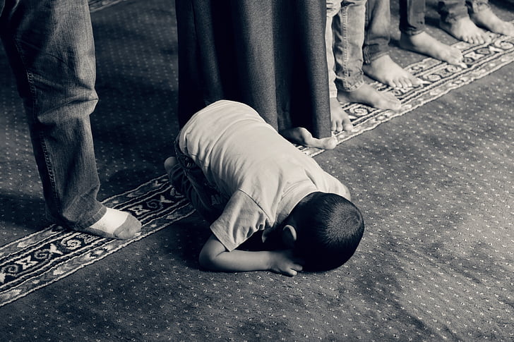 boy in t-shirt praying