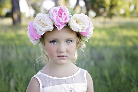 closeup photo of girl wearing white dress and floral headband
