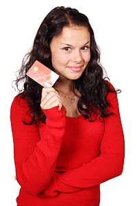 woman wearing red sweater holding red and white magnetic card