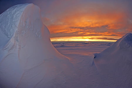 photo of land covered with snow during golden hour