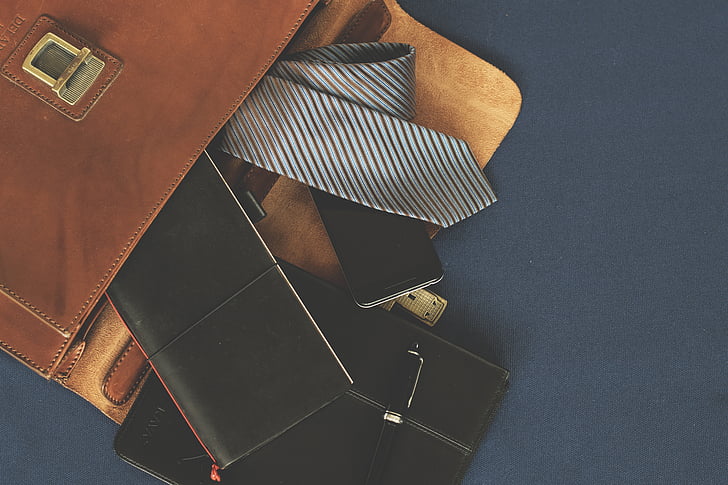 gray and black striped necktie beside black wallet