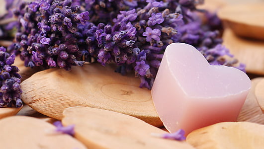 depth of field photography of pink heart soap beside lavender flowers