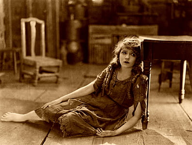 woman leaning on wooden table sepia photography