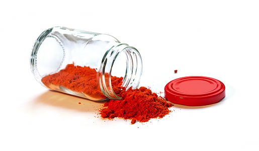 clear glass mason jar with red powder