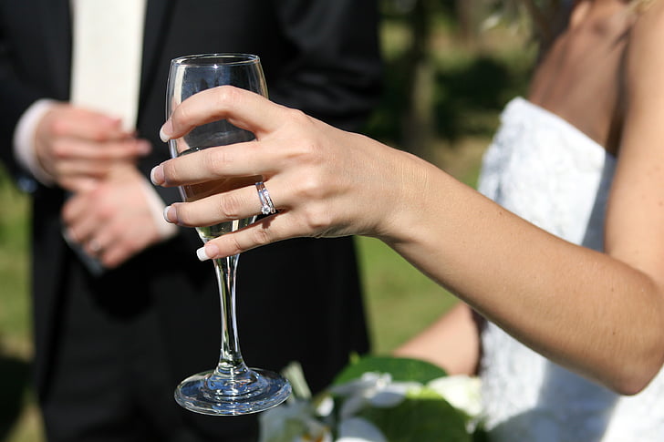 selective focus photography of woman holding clear wine glass