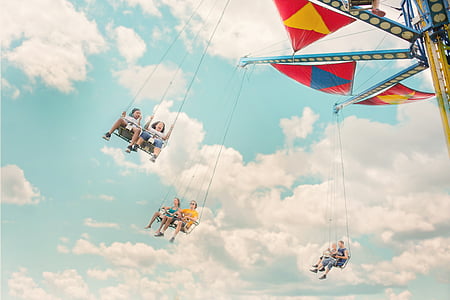 group of people riding swing