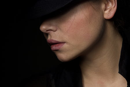 photo of woman wearing hat and black top