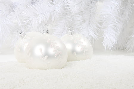 close-up photography of three white baubles near white garland