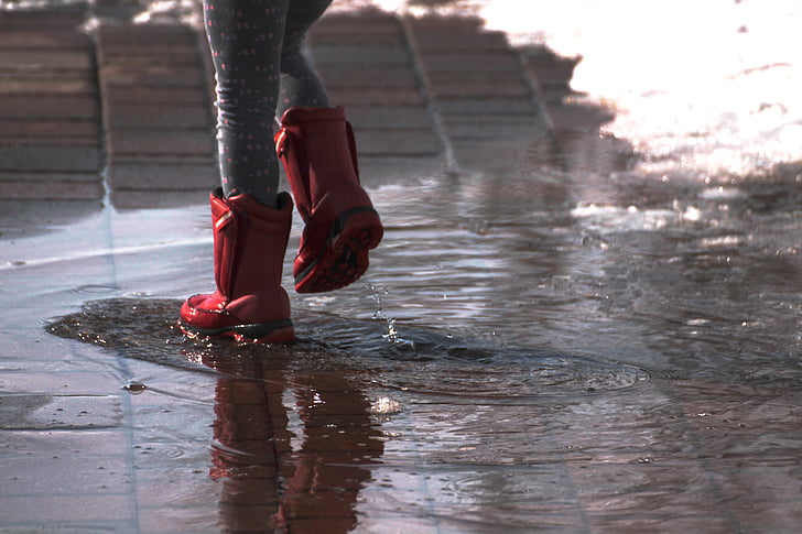woman wears red rain boots